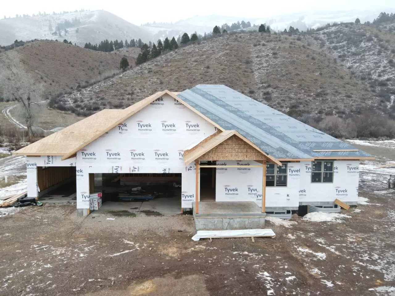 Custom Home with Tyvek wrap in winter from a Licensed Contractor and Builder in Star Valley Ranch Wyoming